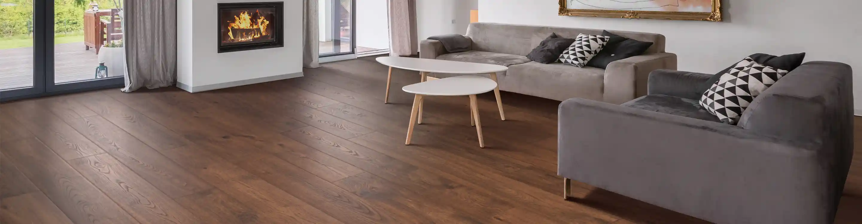 dark laminate wood flooring in living area with gray sectionals